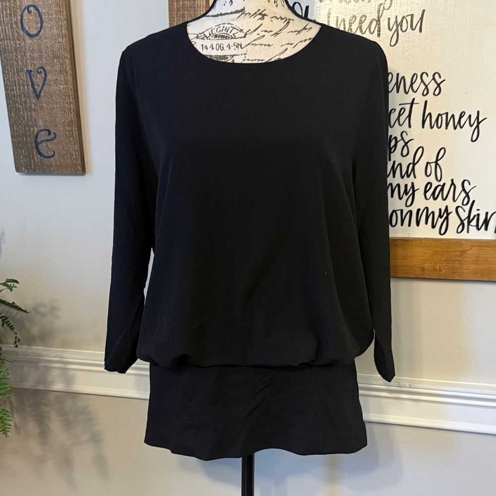 Cabi Indulgence black flounce fitted hem blouse